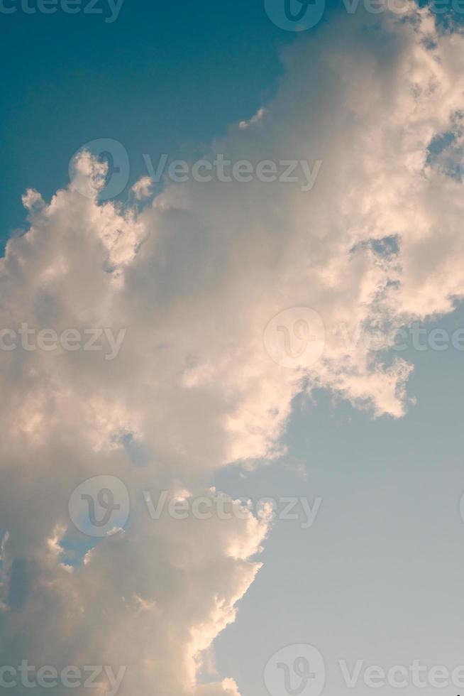 Deep blue sky and high clouds in the sun rays at sunset photo