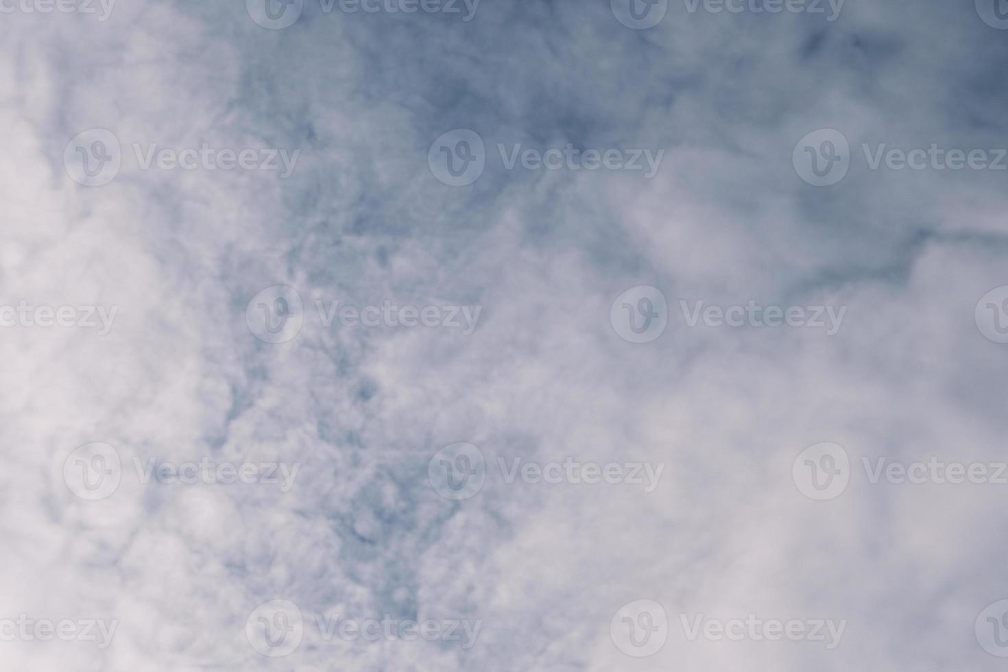 Deep blue sky and high clouds in the sun rays at sunset photo