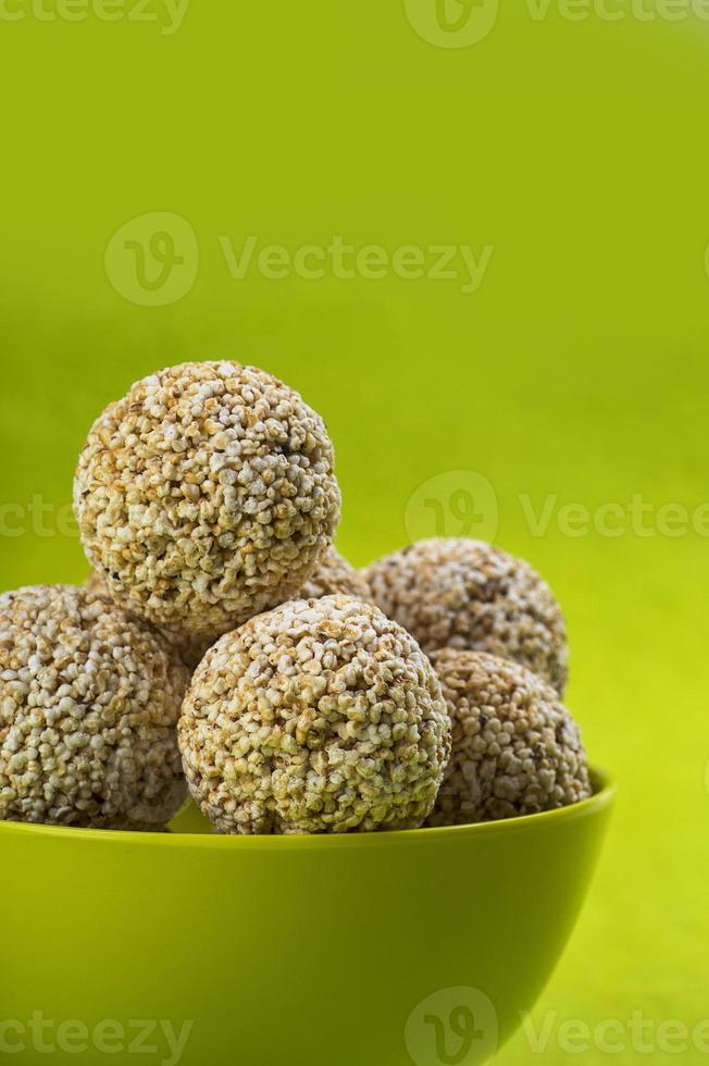 Amaranth or Rajgira laddu, Cholai ke laddo in green Bowl on green background photo