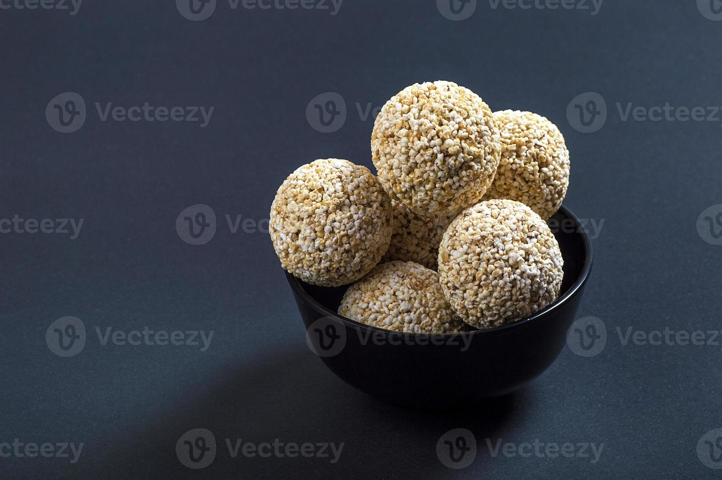 Amaranth or Rajgira laddu, Cholai ke laddo in black Bowl on black background photo