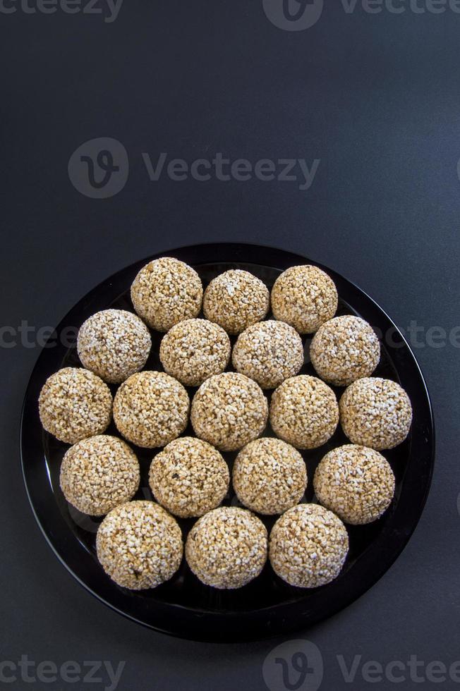 Amaranth ladoo or Rajgira laddu or Cholai ke laddo in black plate on black background. photo