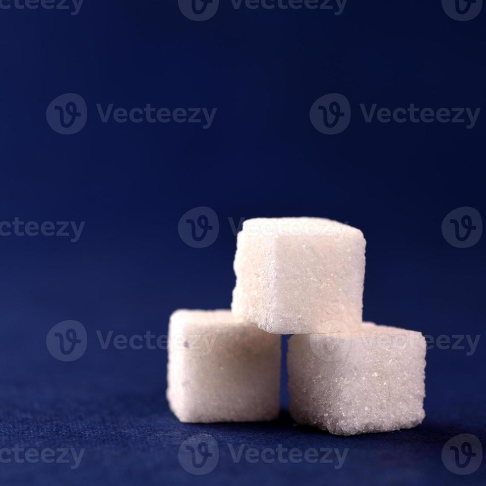 Close-up of Sugar Cubes on Blue Background photo