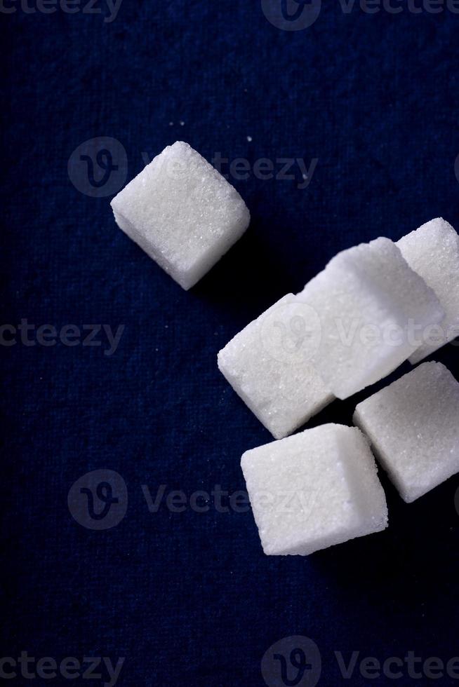 Close-up of Sugar Cubes on Blue Background photo