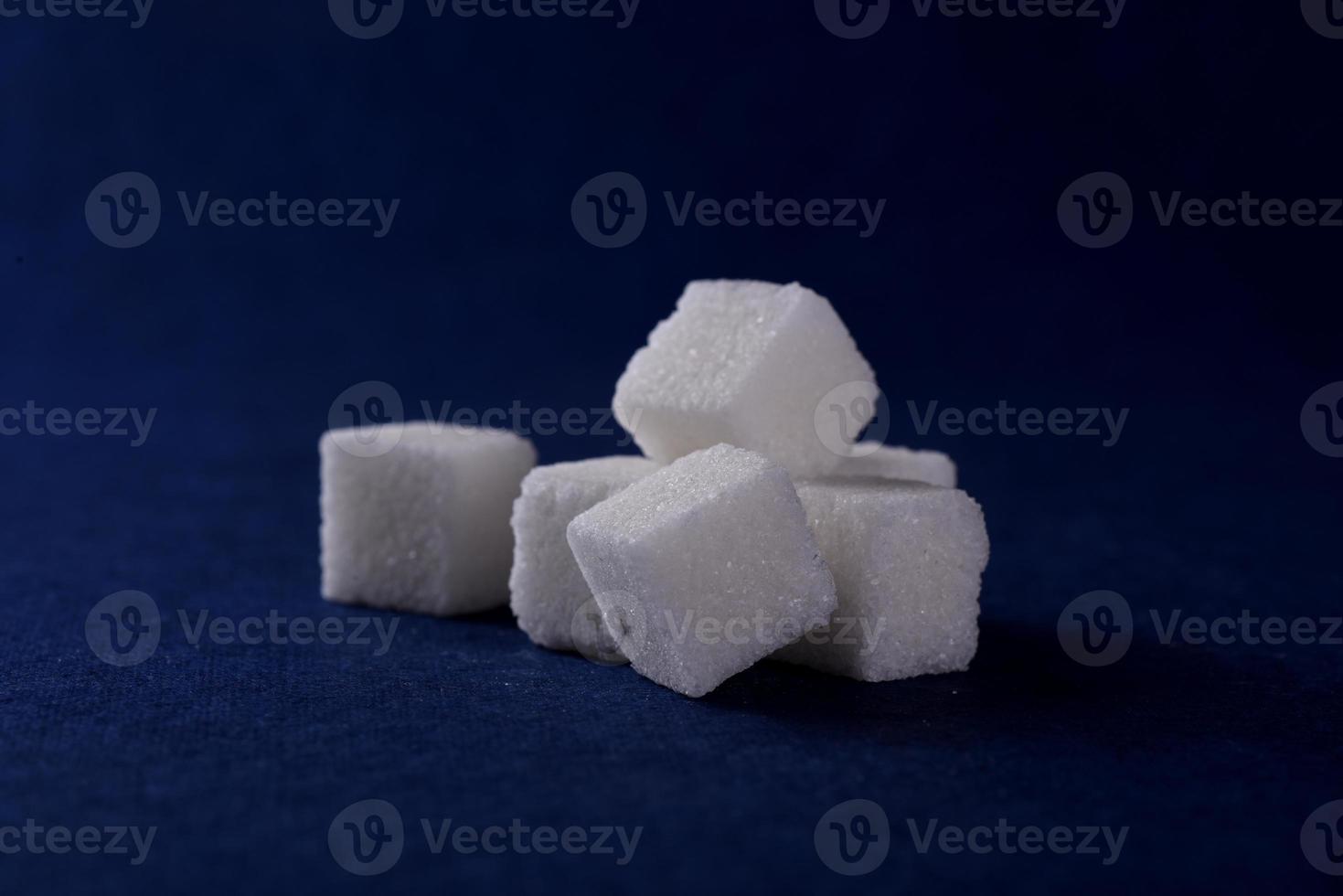 Close-up of Sugar Cubes on Blue Background photo