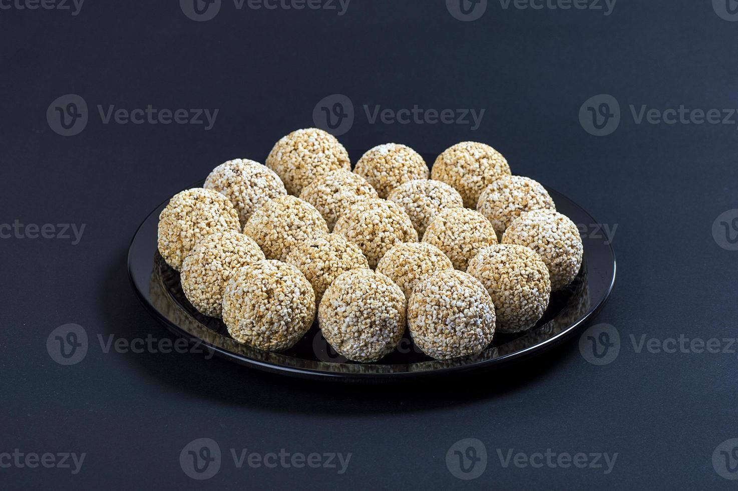 Amaranth ladoo or Rajgira laddu or Cholai ke laddo in black plate on black background. photo