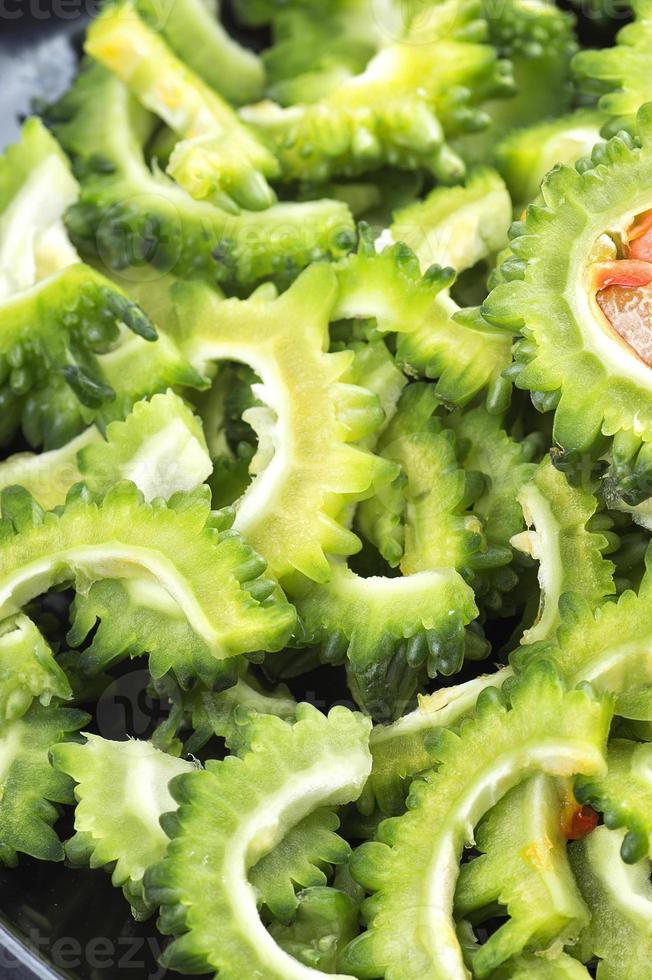 slice of Bitter melon or bitter gourd. Close up of sliced Bitter melon or bitter gourd photo