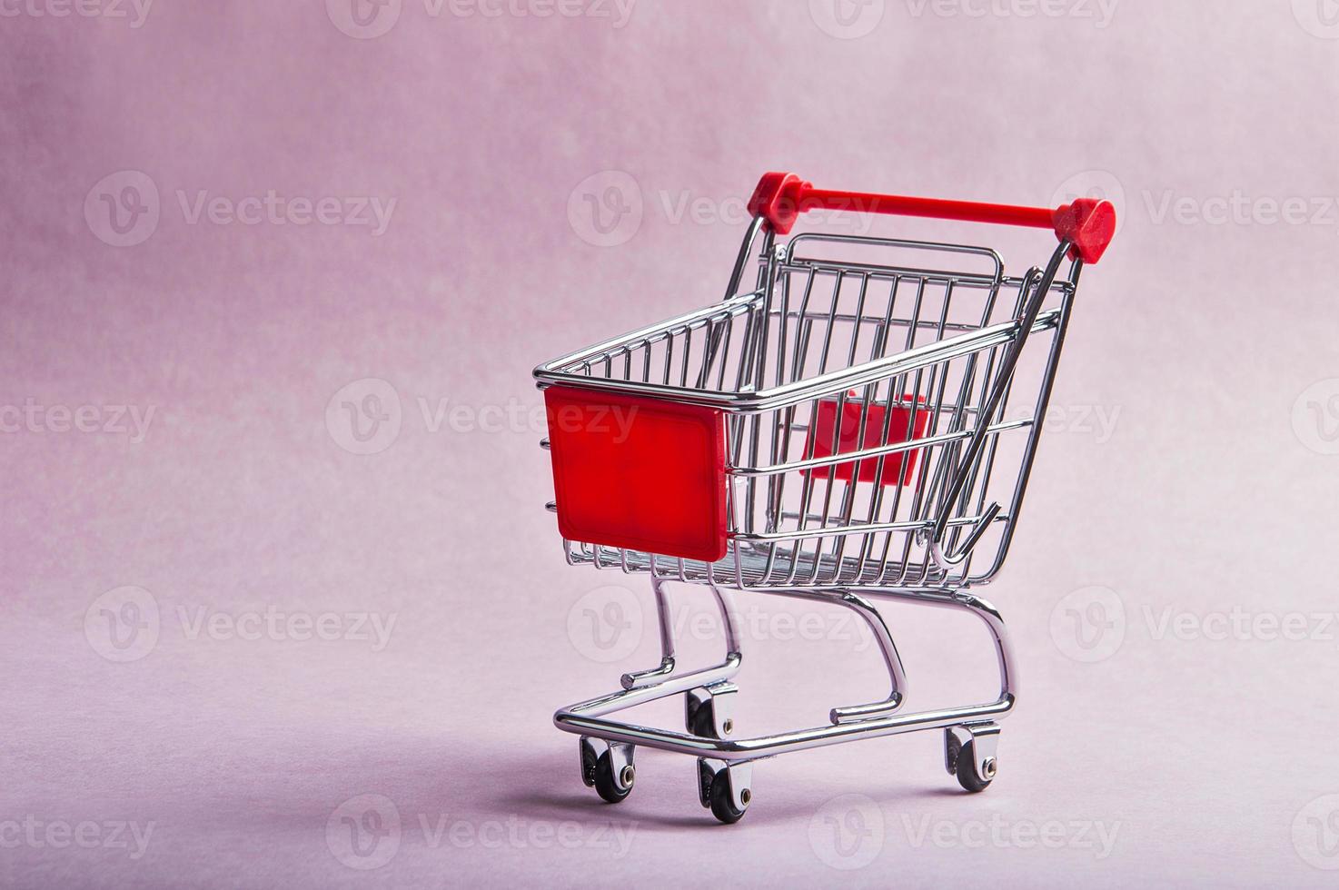 A Shopping Cart or trolly on pink background photo