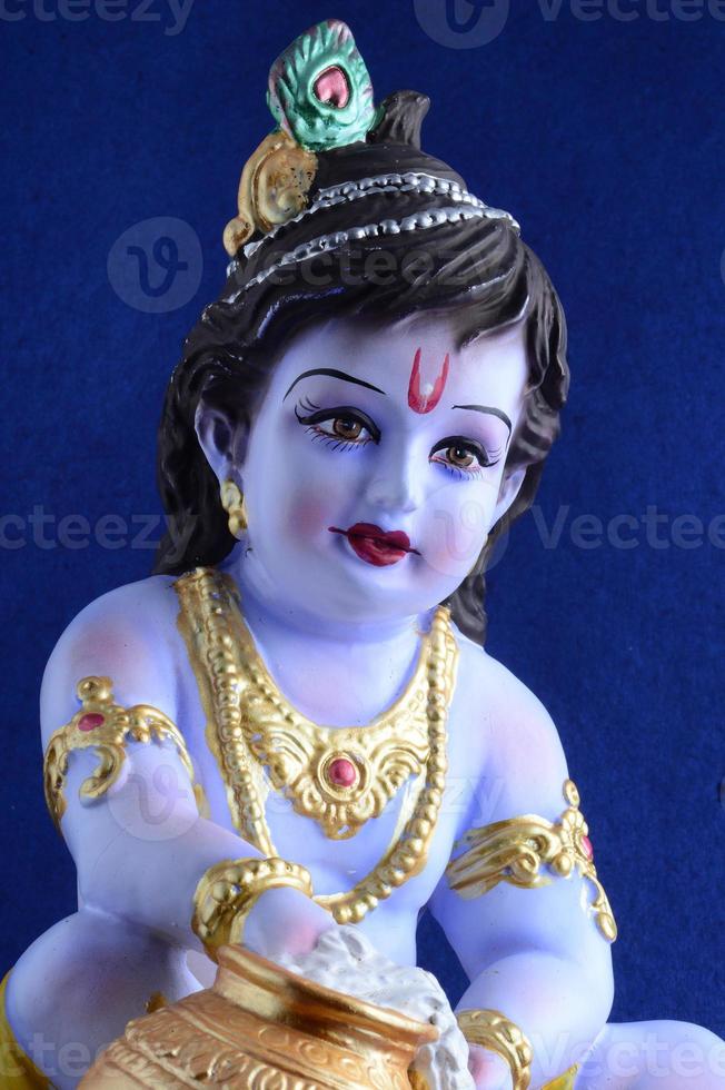 Hindu God Krishna on blue background photo