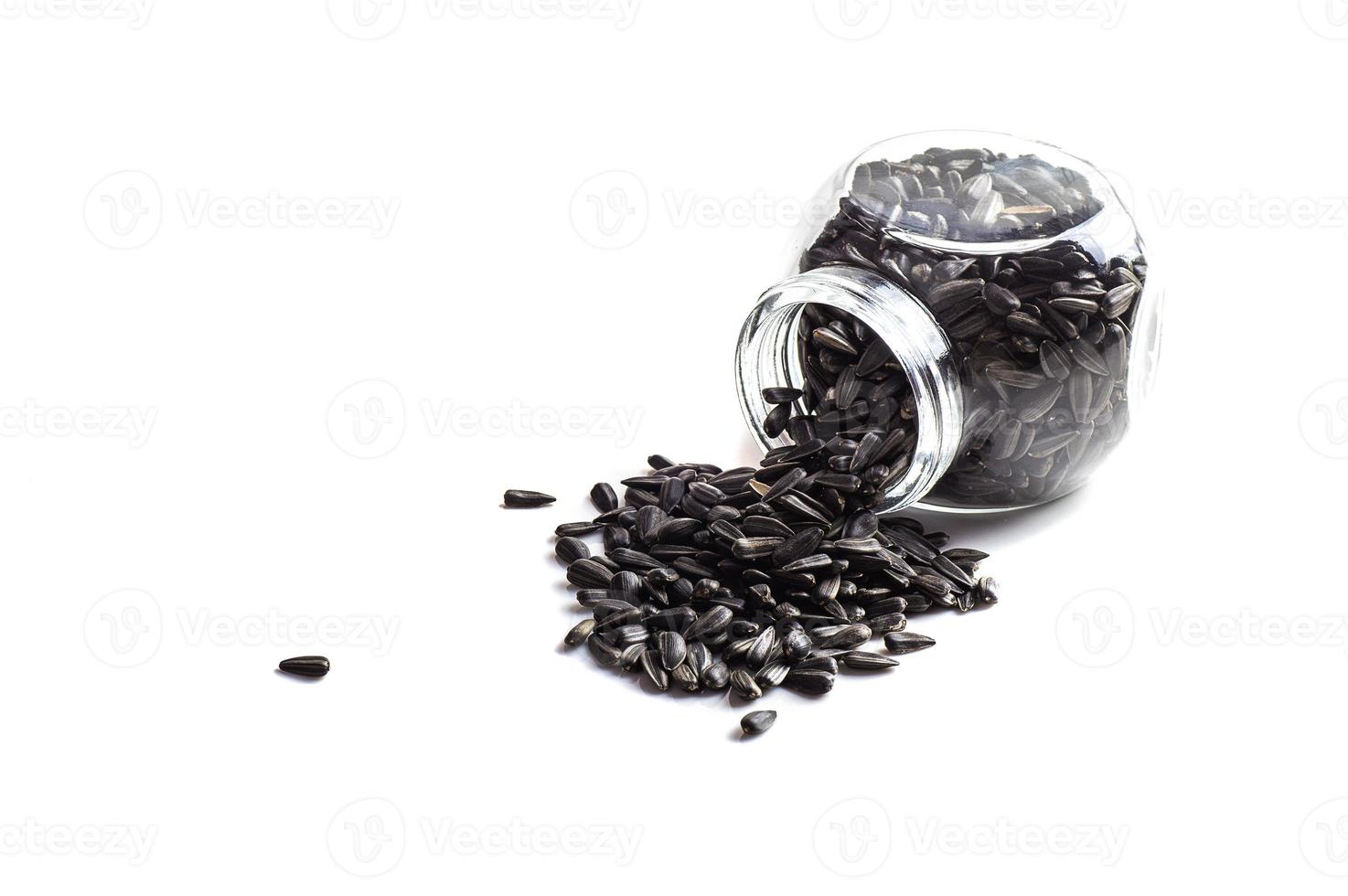 Sunflower Seeds in glass pot on white background. Helianthus annuus. photo