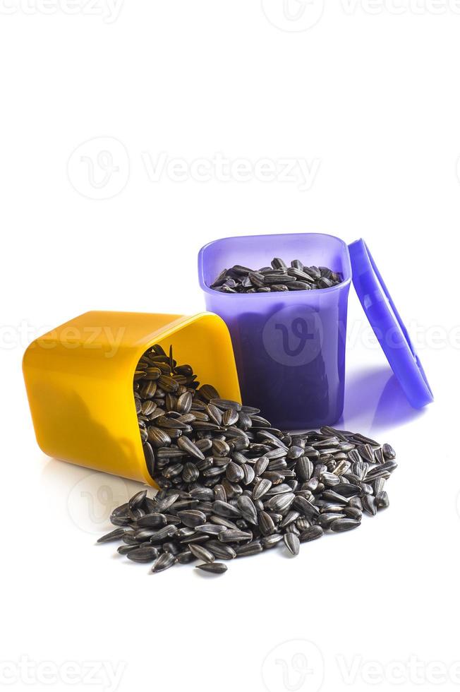 Sunflower Seeds in container on white background. Helianthus annuus. photo