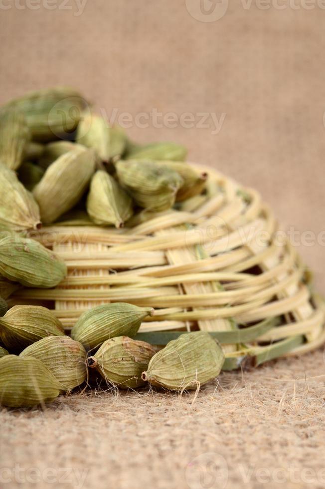 Green Cardamom pods on sack cloth photo