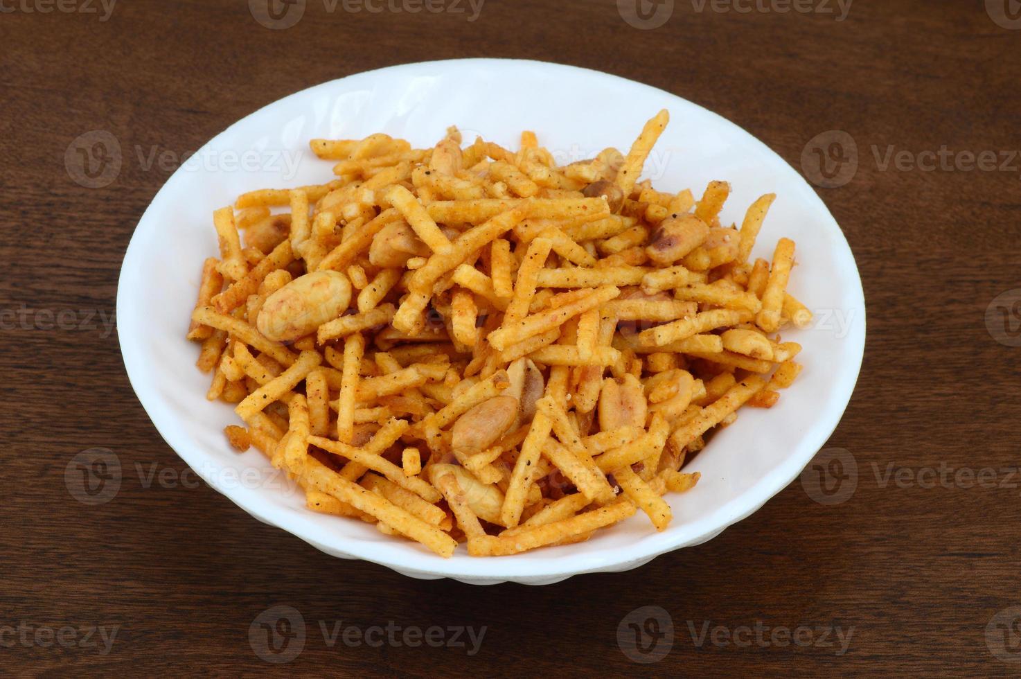 Deep fried salty dish - chivda or mixture made of gram flour and mixed with dry fruits. photo
