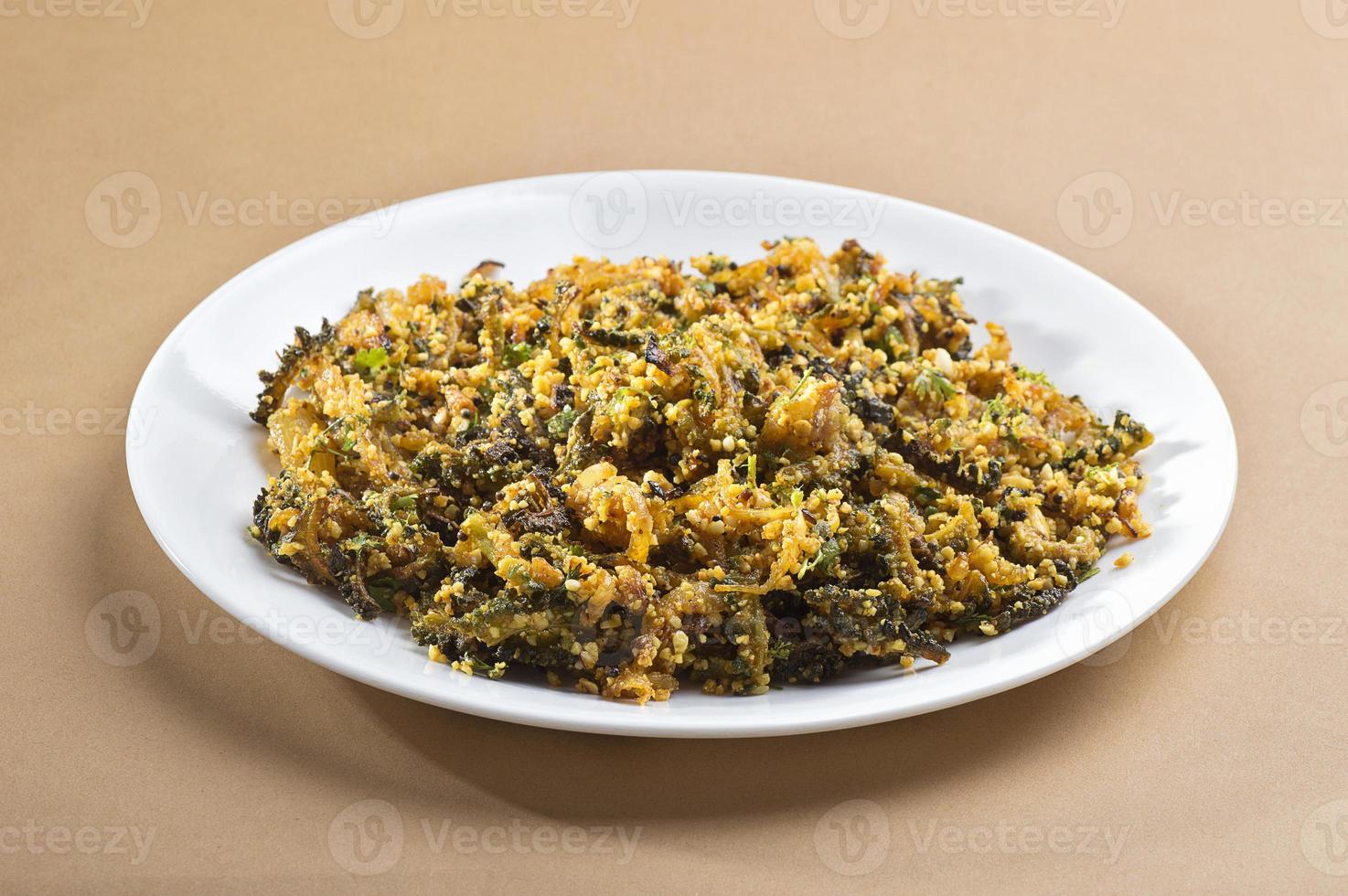Indian Dish Bitter gourd fry with spices and herbs photo