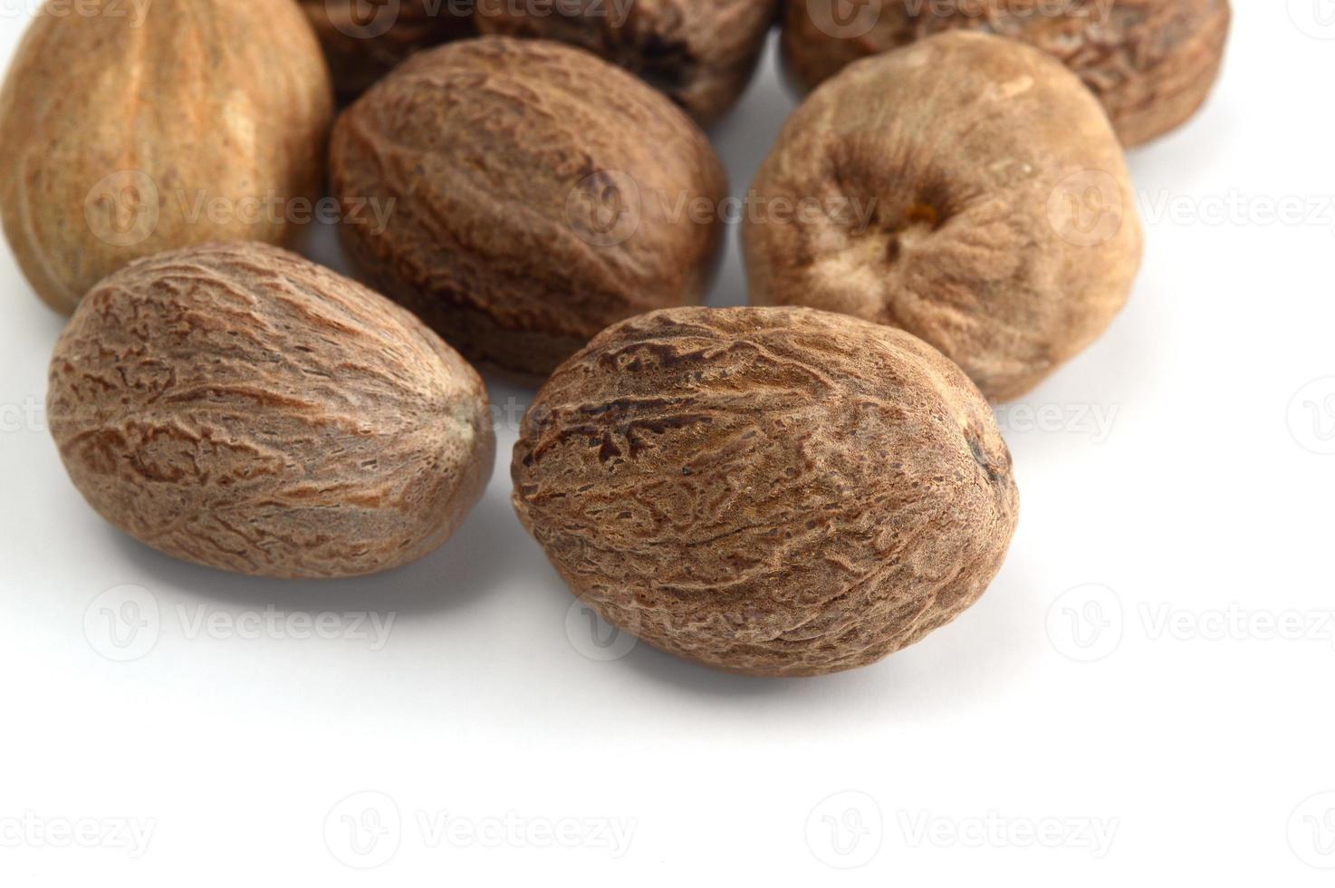 Nutmeg isolated on white background. Close up. photo