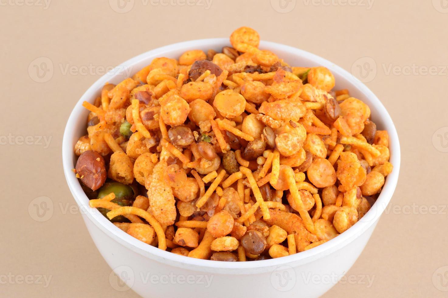 Indian Snacks Mixture roasted nuts with salt pepper masala, pulses, channa masala dal green peas in blue bowl in photo