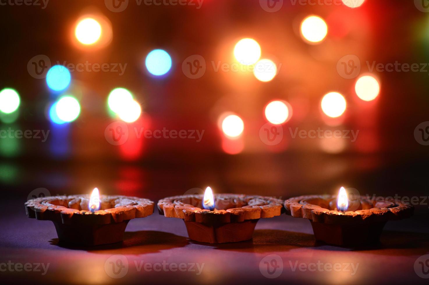 Clay diya lamps lit during Diwali Celebration. Greetings Card Design Indian Hindu Light Festival called Diwali photo