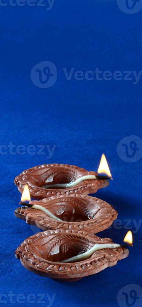 Clay diya lamps lit during diwali celebration. Greetings Card Design Indian Hindu Light Festival called Diwali photo