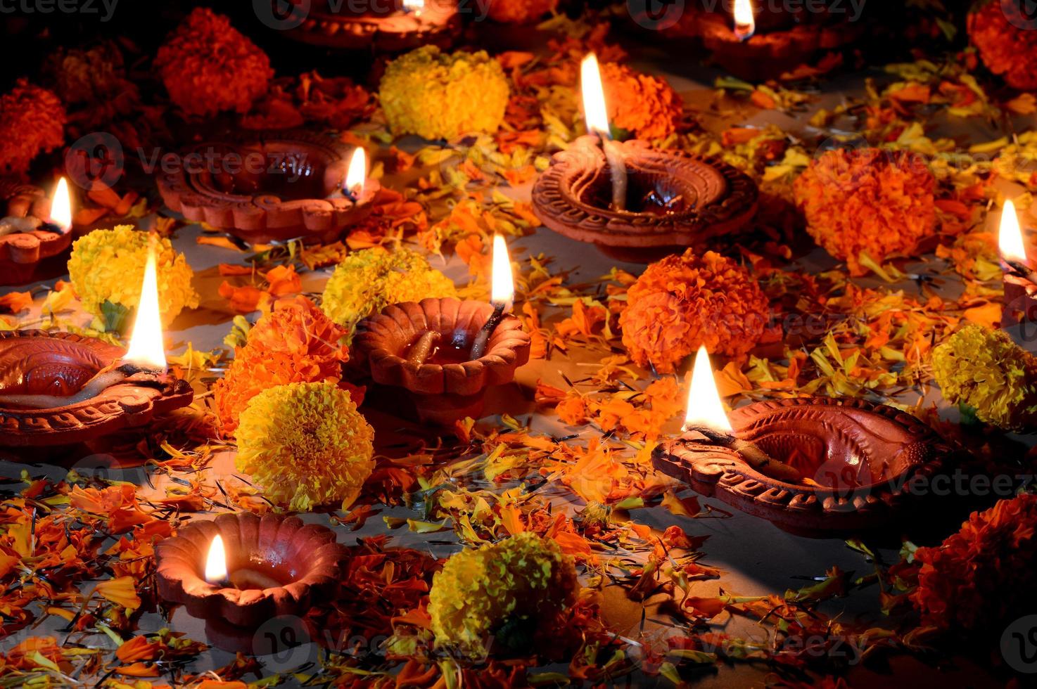 Clay diya lamps lit during Diwali Celebration. Greetings Card Design Indian Hindu Light Festival called Diwali photo