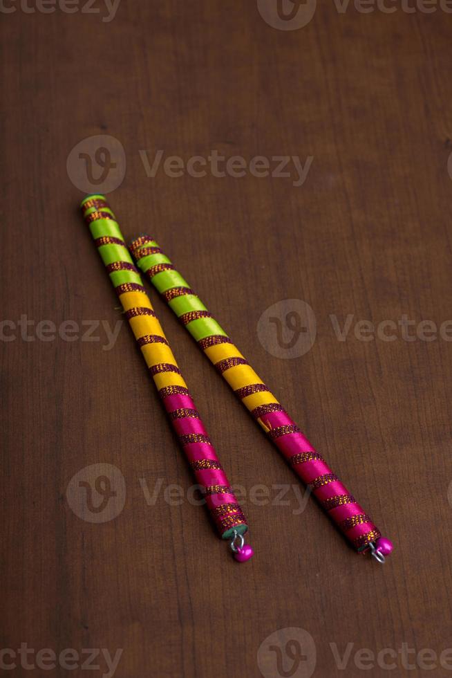 Dandiya sticks on a brown background. Raas Garba or Dandiya Raas is the traditional folk dance photo