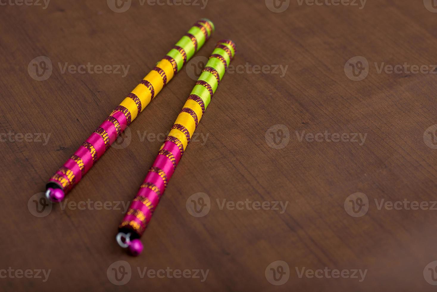 Dandiya sticks on a brown background. Raas Garba or Dandiya Raas is the traditional folk dance photo