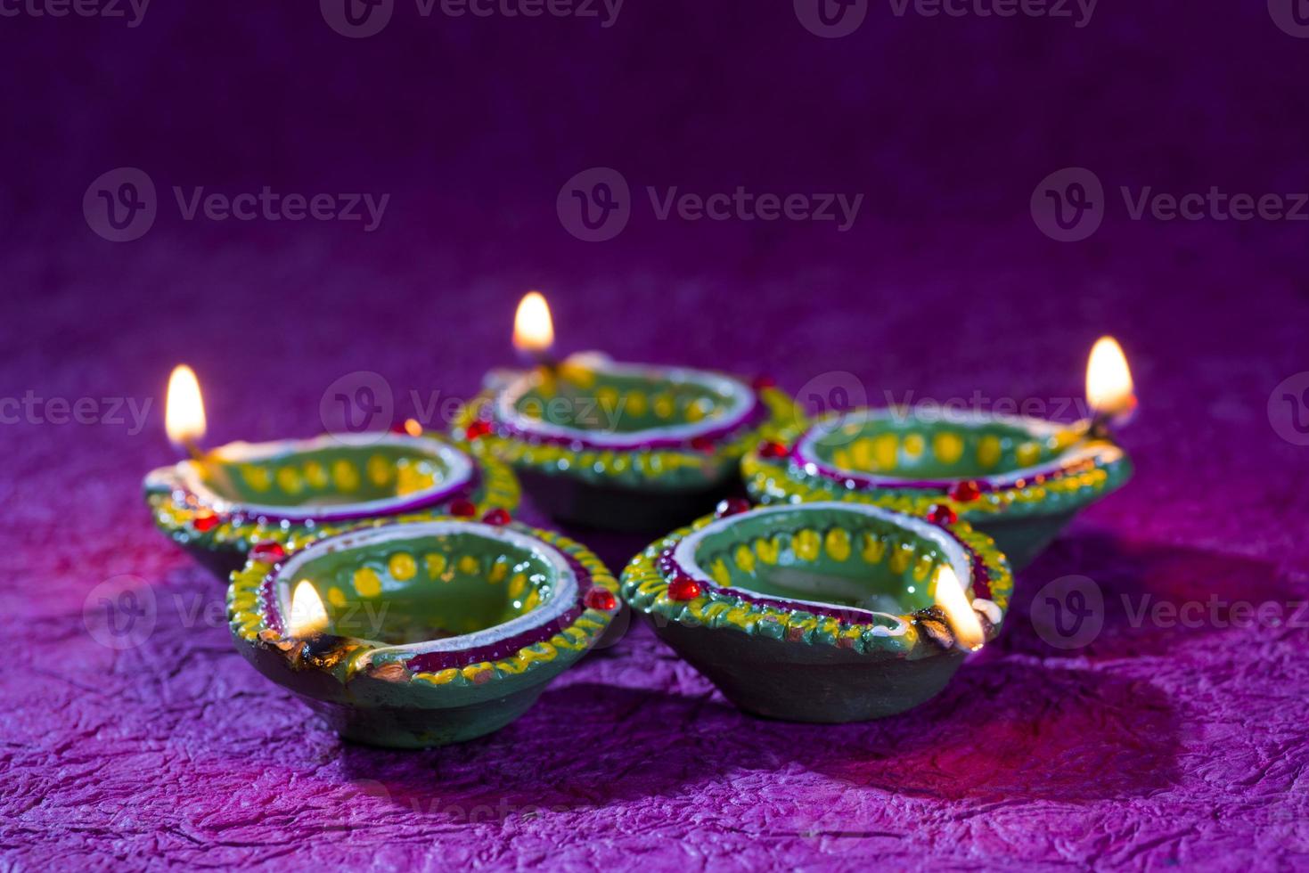 Clay diya lamps lit during Diwali Celebration. Greetings Card Design Indian Hindu Light Festival called Diwali photo