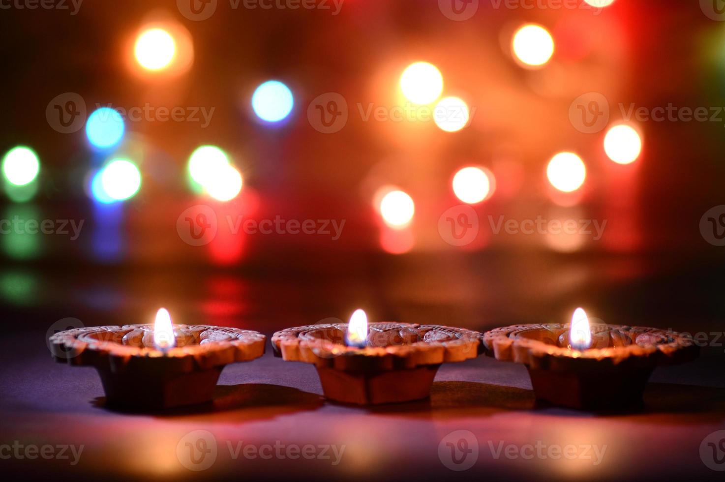 Clay diya lamps lit during Diwali Celebration. Greetings Card Design Indian Hindu Light Festival called Diwali photo