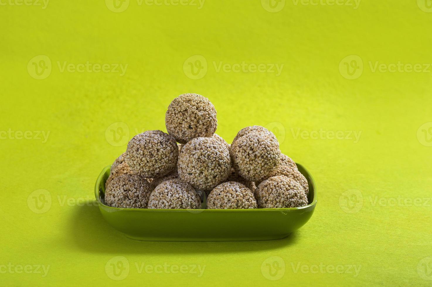Amaranth or Rajgira laddu, Cholai ke laddo in green plate on green background photo