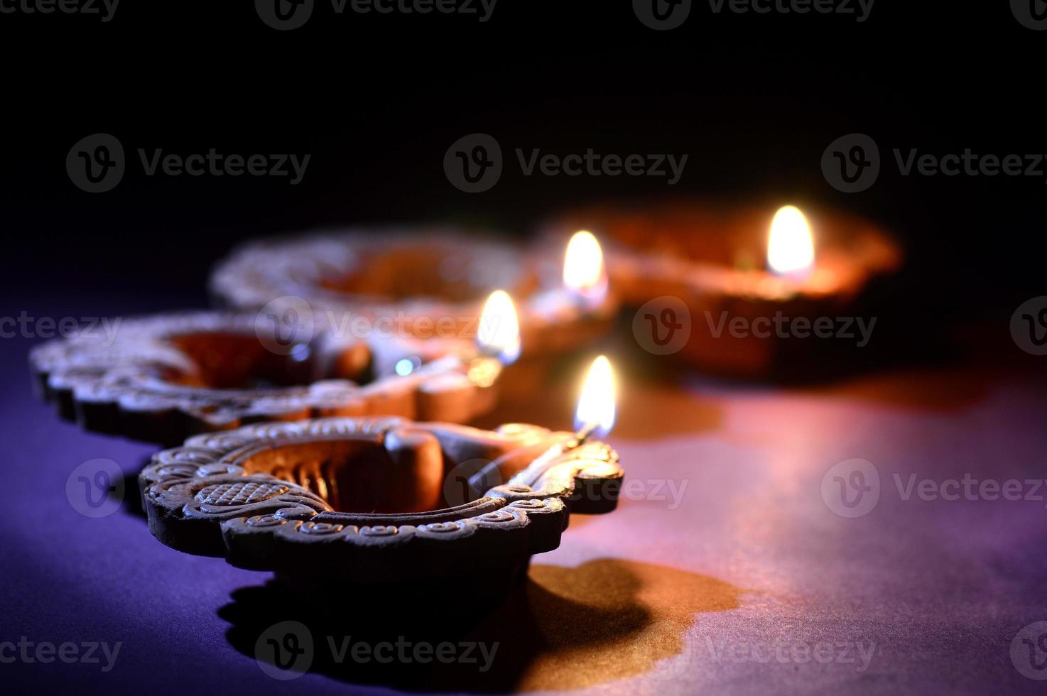 Colorful clay Diya Lantern lamps lit during Diwali celebration. Greetings Card Design Indian Hindu Light Festival called Diwali. photo