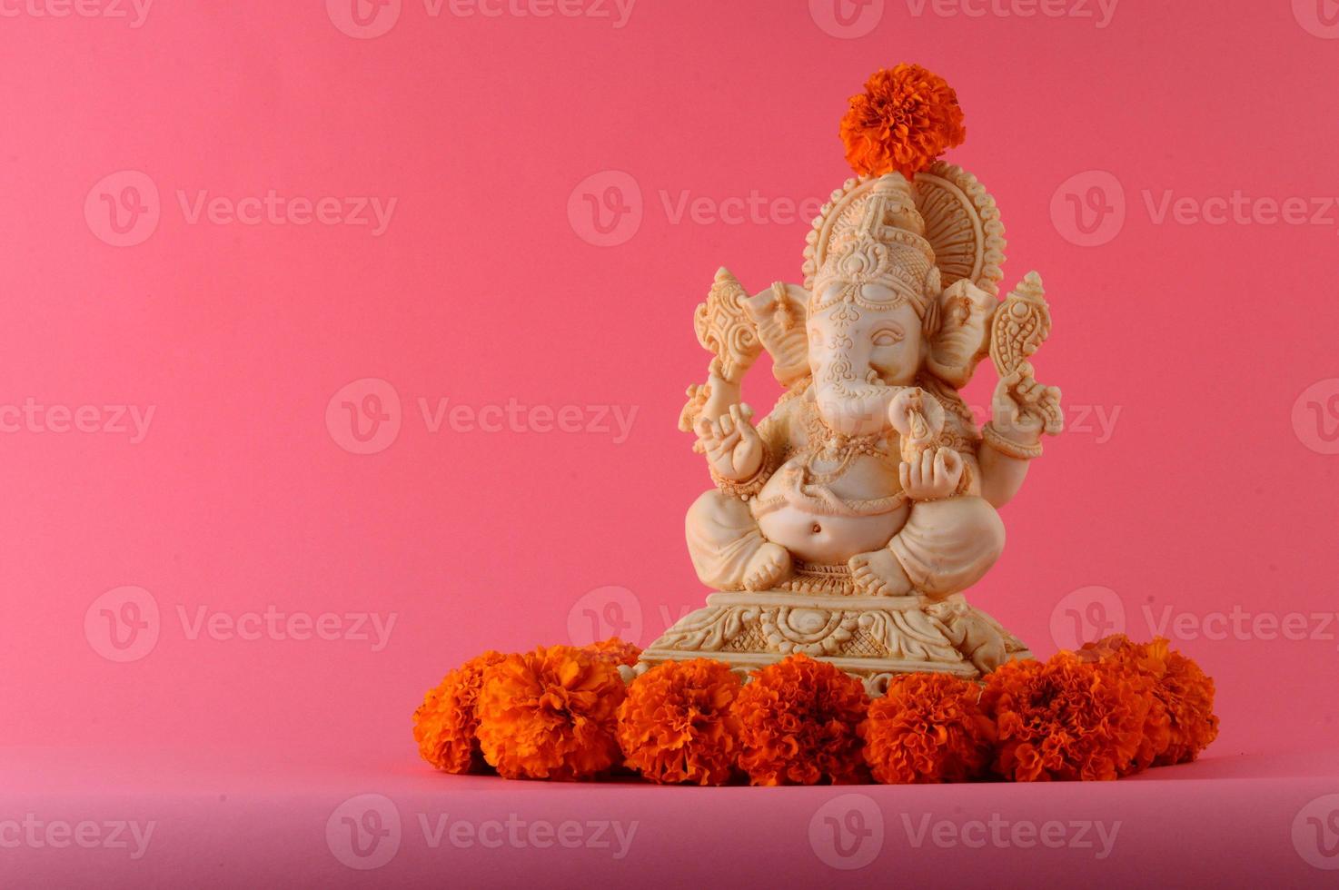 Hindu God Ganesha. Ganesha Idol on pink background photo