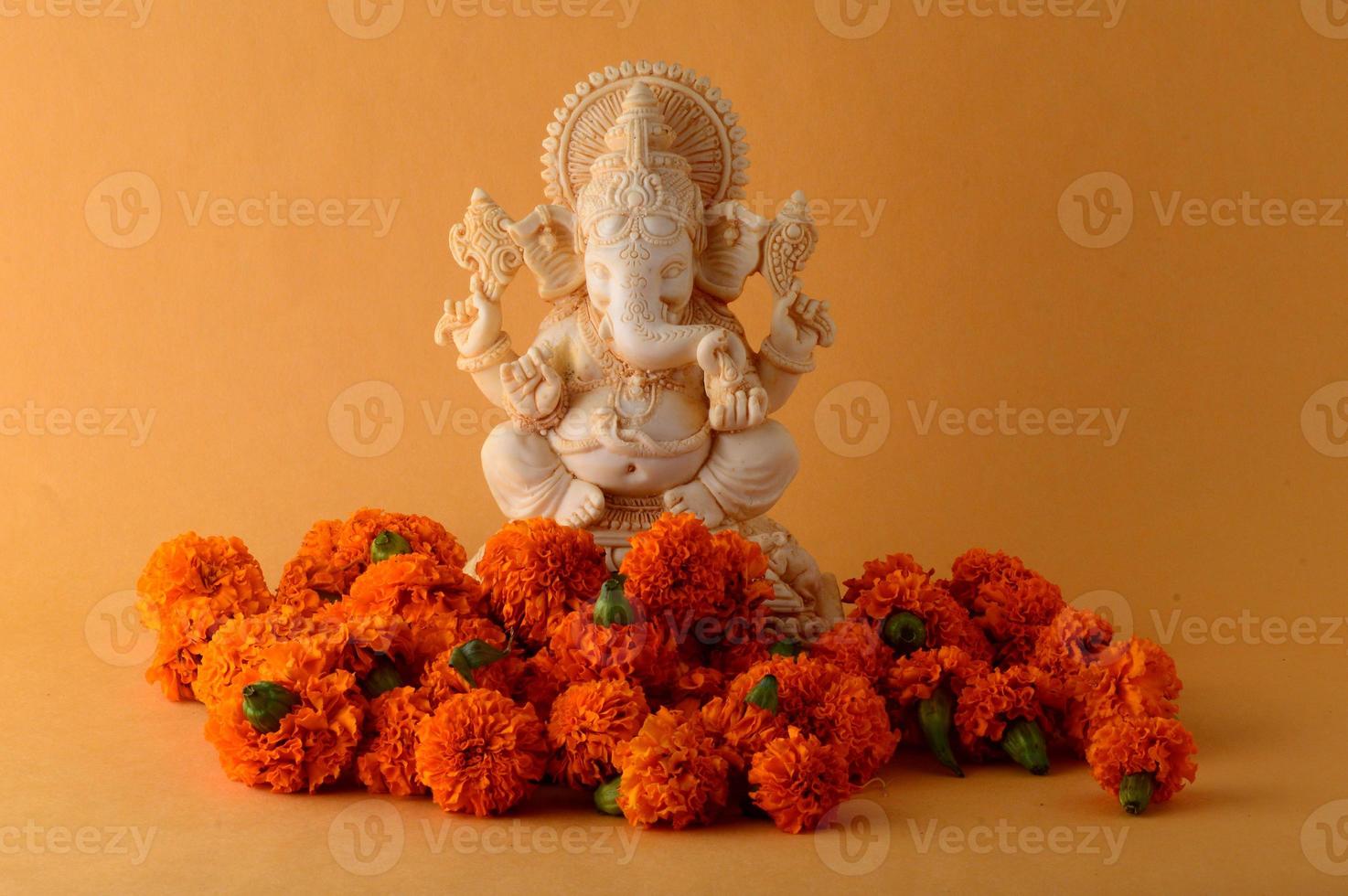 Hindu God Ganesha. Ganesha Idol on yellow background photo