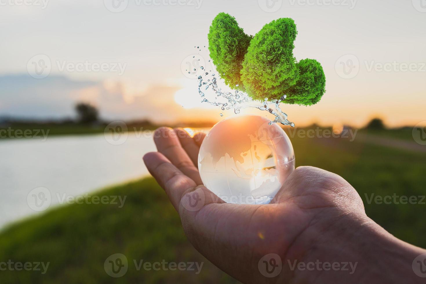 Globe glass on hand with sunrise photo