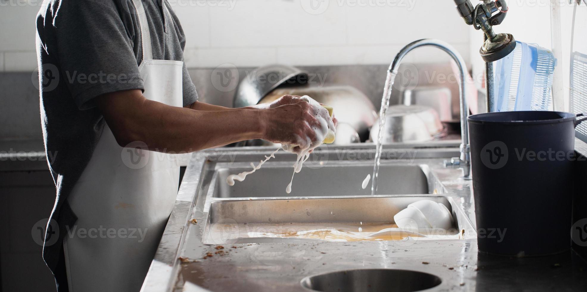 Man washing dish photo