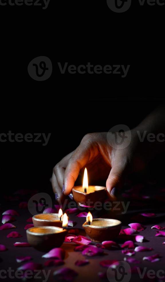 Hand holding and arranging lantern, Diya during Diwali Festival of Lights photo