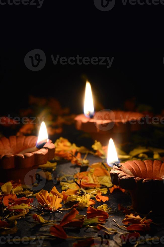 Clay diya lamps lit during Diwali Celebration. Greetings Card Design Indian Hindu Light Festival called Diwali photo