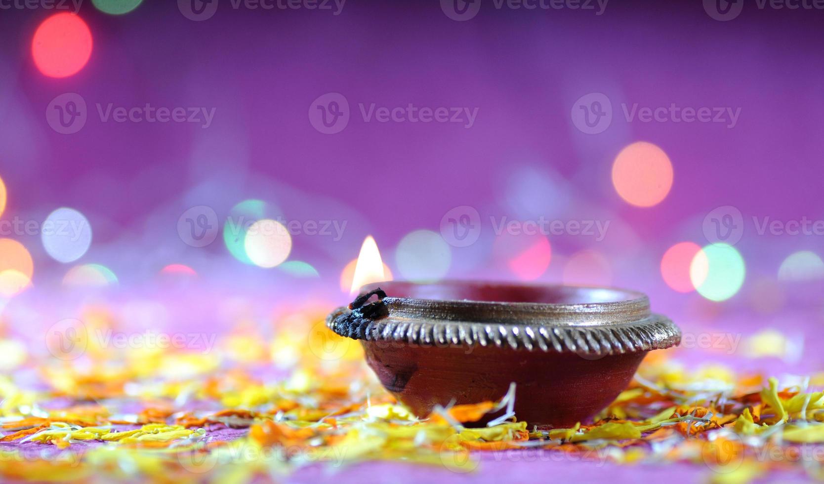 Clay diya lamps lit during Diwali Celebration. Greetings Card Design Indian Hindu Light Festival called Diwali photo