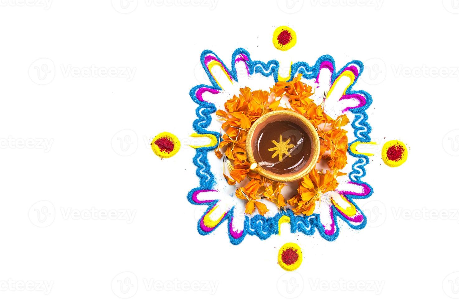 Clay diya lamp lit during diwali festival. Clay Diya on Rangoli. Happy Diwali Greetings Card Design, Indian Hindu Festival of Lights called Diwali. photo