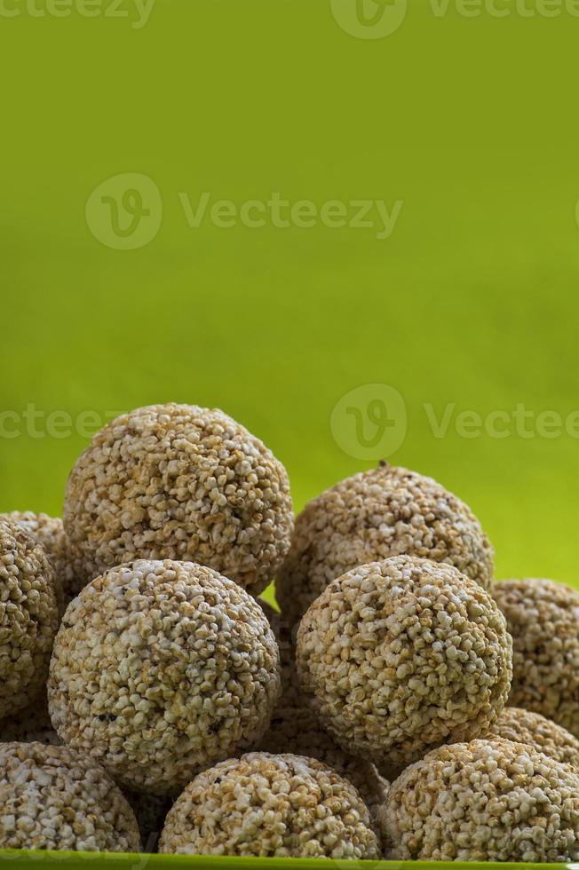 Amaranth or Rajgira laddu, Cholai ke laddo in green plate on green background photo