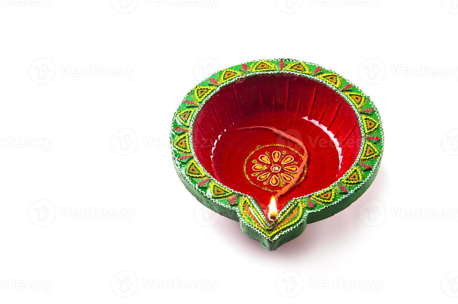 Single Clay diya lamp lit during diwali festival. Happy Diwali Greetings Card Design, Indian Hindu Festival of Lights called Diwali. photo