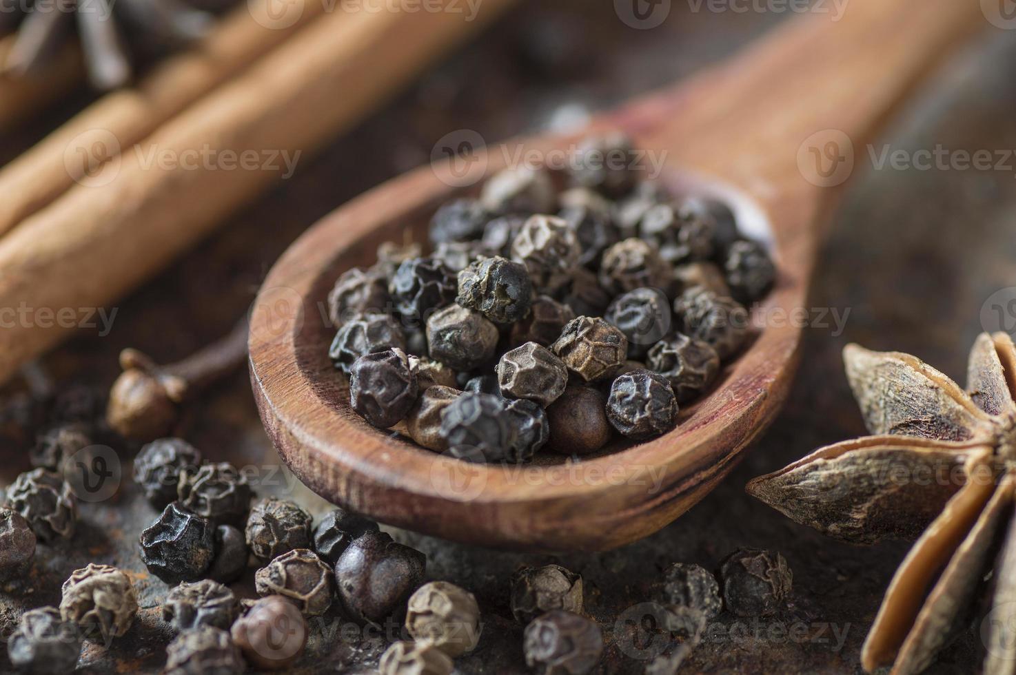 Spices and herbs. Food and cuisine ingredients. Cinnamon sticks, anise stars, black peppercorns and cardamom on a textured background. photo