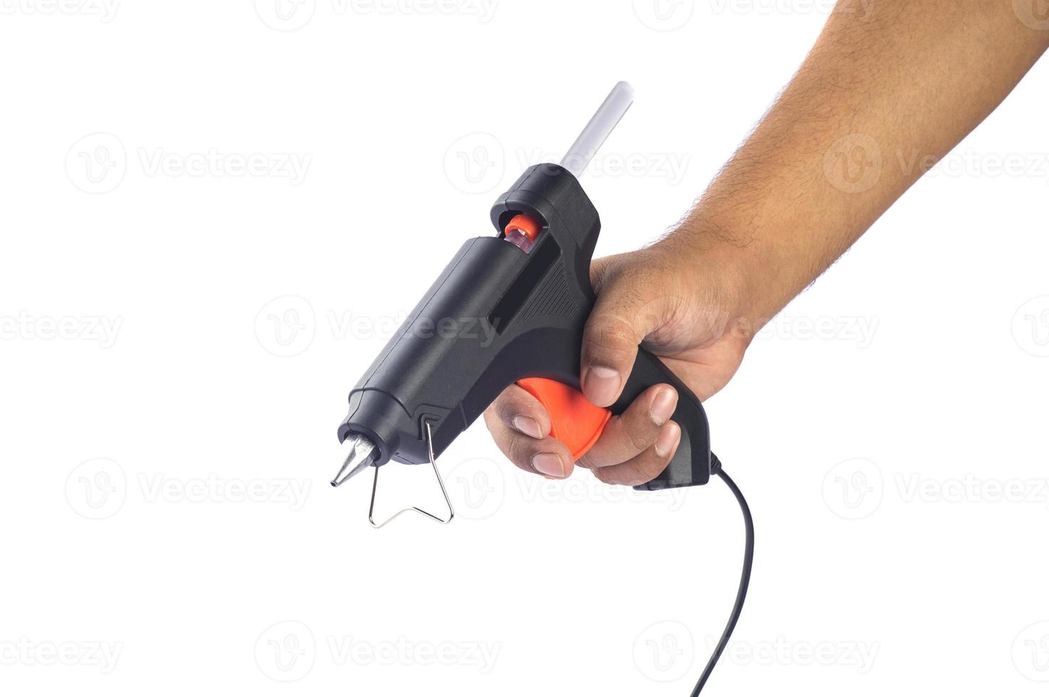 Hand holding Electric hot glue gun isolated on white background photo