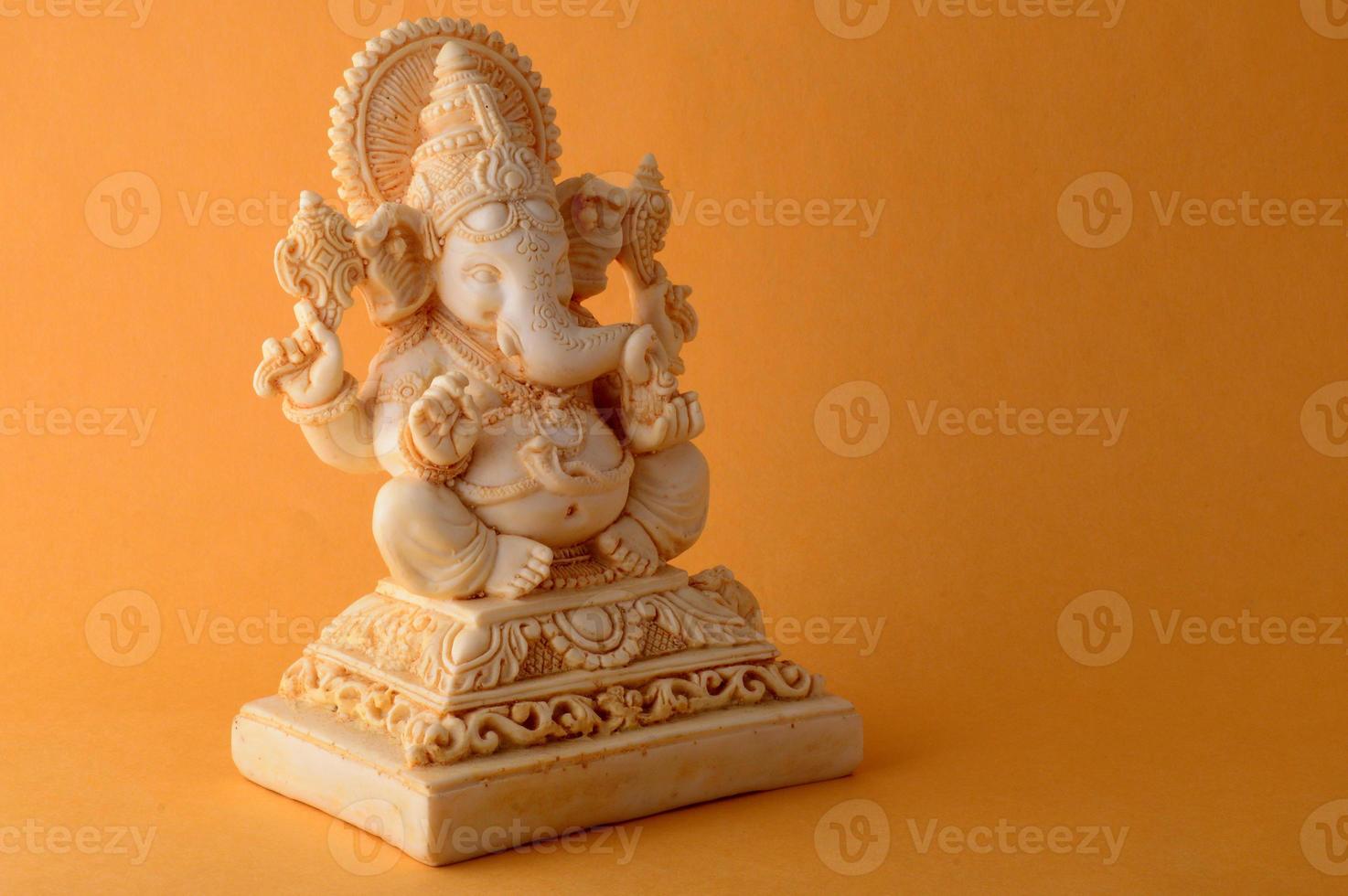 Hindu God Ganesha. Ganesha Idol on yellow background photo