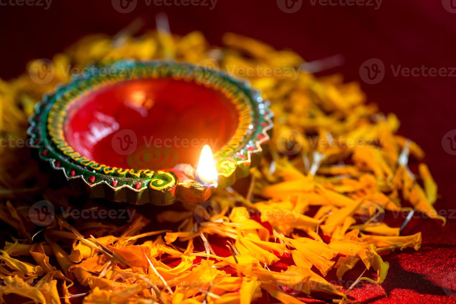 Happy Diwali - Clay Diya lamps lit during Diwali celebration. Greetings Card Design of Indian Hindu Light Festival called Diwali photo