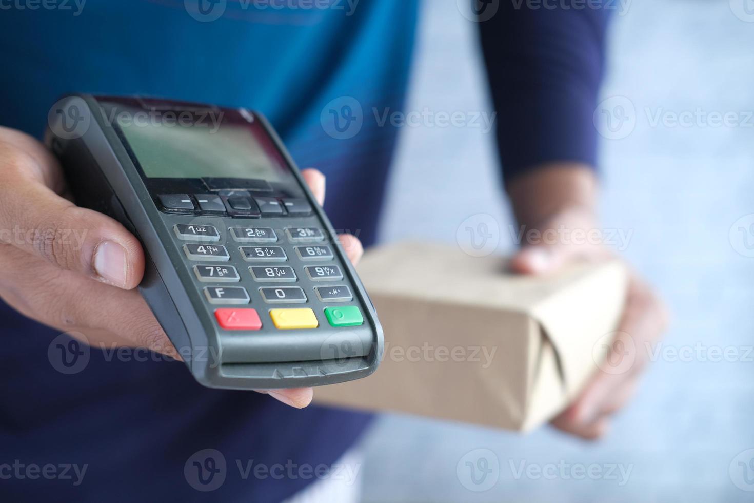 hand holding pos machine close up . photo