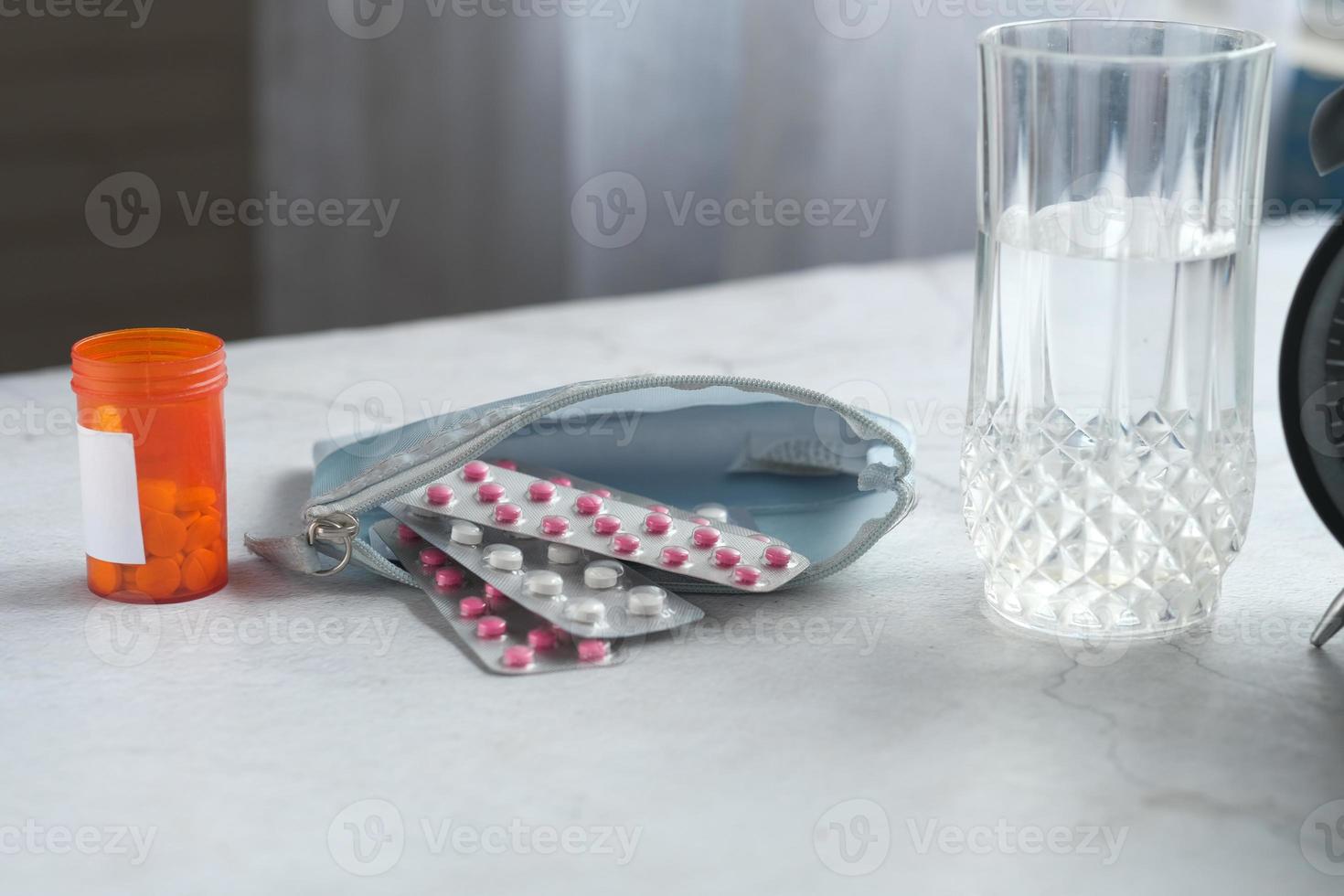 Close up of pills of blister pack in a small bag on table at home photo