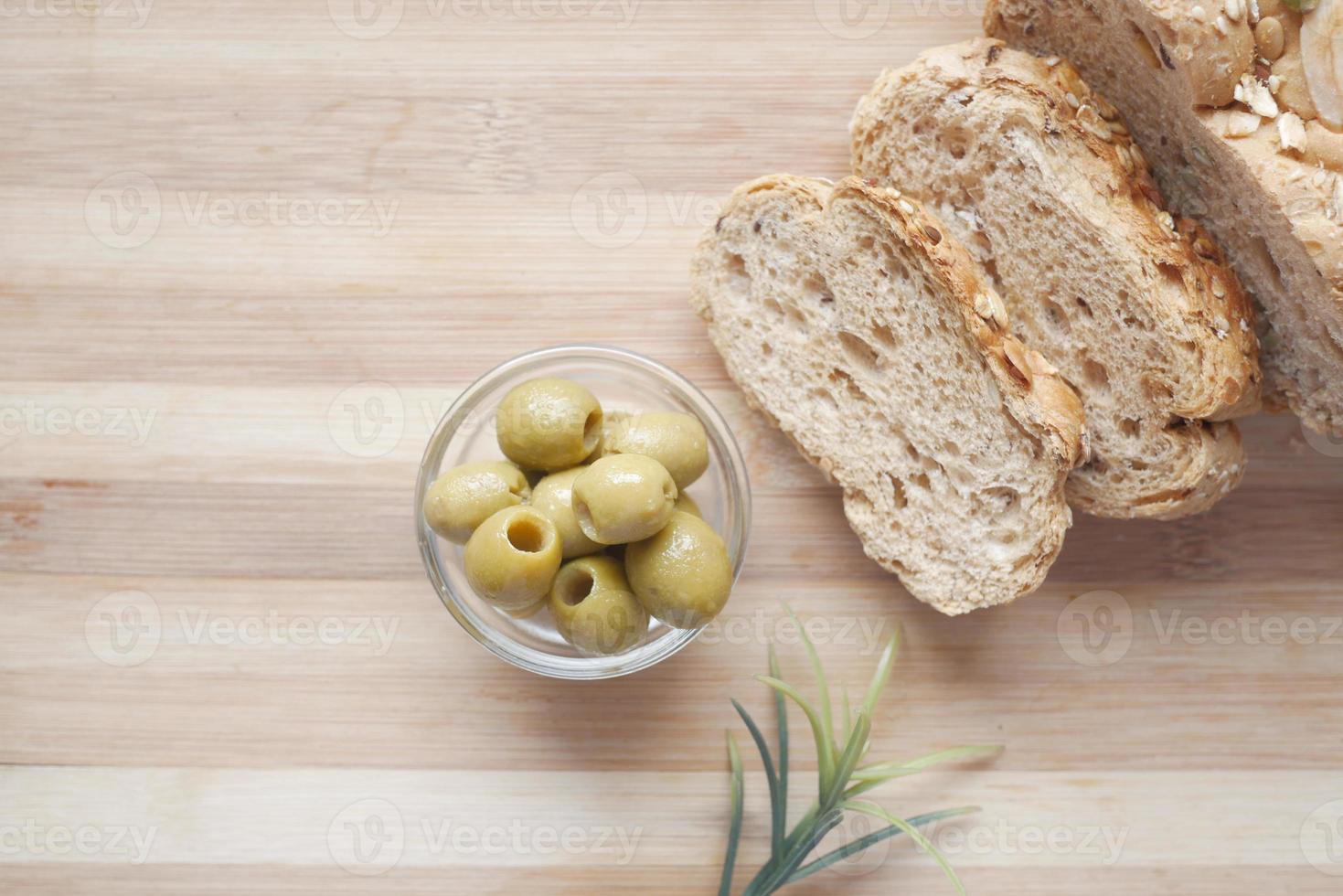 Rebanada de pan integral y aceite de oliva en la mesa foto