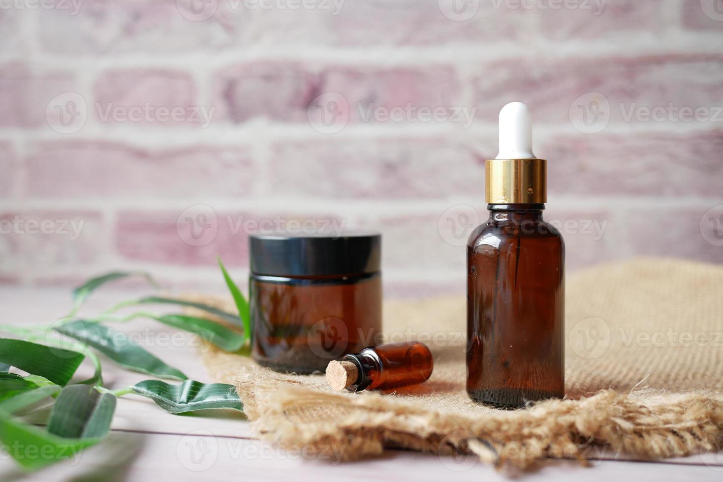 eucalyptus essential oils in a glass bottle with green leaf on white background photo