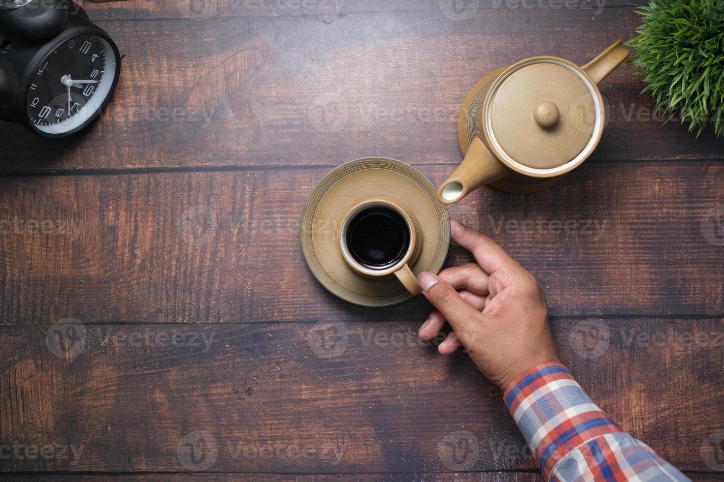 hand holding cup of green tea with copy space photo