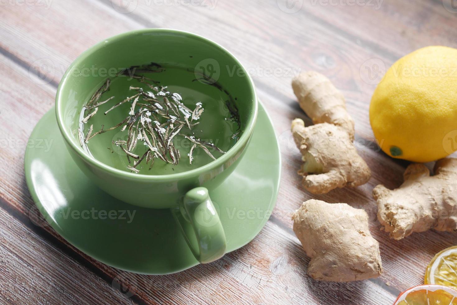 Top view of ginger tea on wooden background. photo