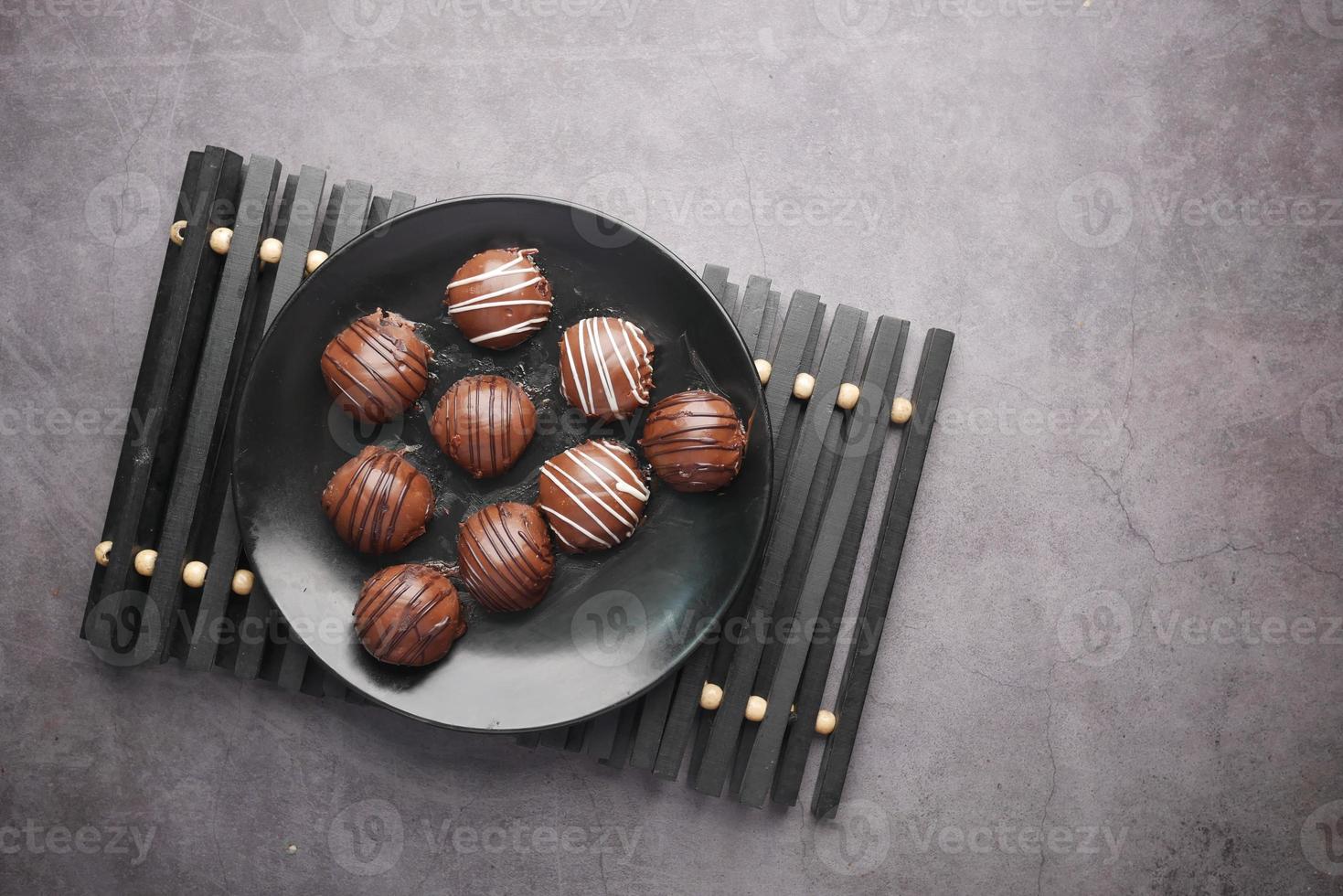 dark chocolate on a plate on black background photo