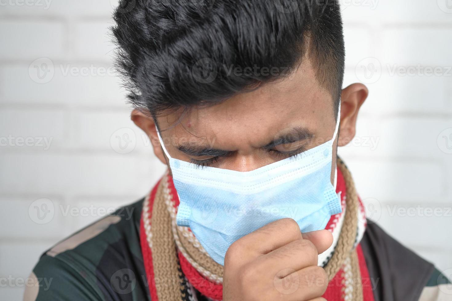 young sick man coughing and sneezes photo